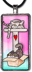 Original art pendant or keychain features 2 cats, one lounging in a kitty treehouse, the other playing in a cardboard box.