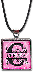 Classic split monogram name jewelry is available with pink or blue background, as a necklace or keychain.