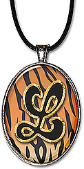 Handcrafted monogram necklace or keychain features a tiger print background and a bold initial.